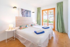 A bed or beds in a room at Villa d'Es Trenc
