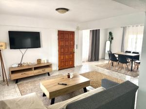 a living room with a couch and a tv at Tsina’s apartments in Ágios Nikólaos