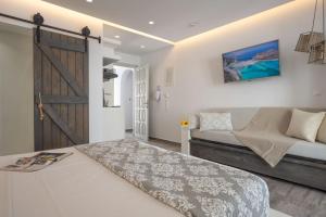 a bedroom with a bed and a sliding door at Sienalice Naxos Next to The Beach in Naxos Chora