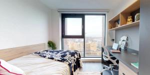 a bedroom with a bed and a desk and a window at Canvas Arundel House in Coventry in Coventry +32 photos