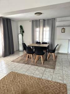 a dining room with a table and chairs at Tsina’s apartments in Ágios Nikólaos