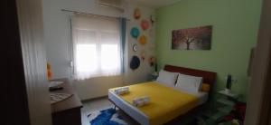 A bed or beds in a room at KIKI APARTMENT