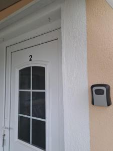 a white door with the number on it at Apartments Anđela in Skradin