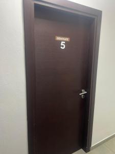 a brown elevator door with the number on it at Centrally Located Private Rooms in Heraklio Town