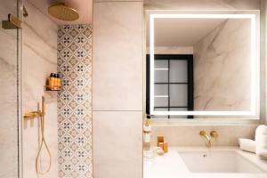 a bathroom with a sink and a mirror at The Mercantile Hotel in Dublin