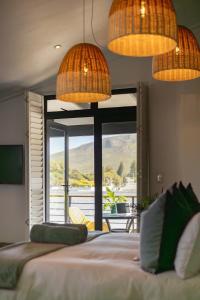 a bedroom with a bed with a view of the mountains at Mountain-View Studio Apartment, Hermanus Waterfront - Apt 6 in Hermanus