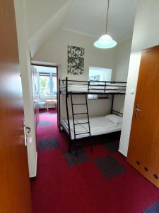 a room with two bunk beds and a hallway at Wille Amber in Mielno