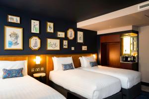 Ένα ή περισσότερα κρεβάτια σε δωμάτιο στο The Mercantile Hotel
