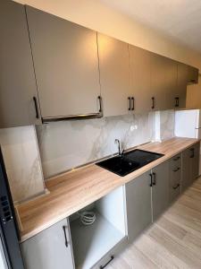a kitchen with white cabinets and a sink at Ble Studios in Nikiti +8 photos