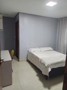 a bedroom with a bed in a room with a window at Casa de alto padrão in Macacos +5 photos