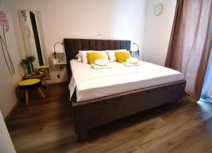 a bedroom with a large bed with yellow pillows at Dubrovnik Icy Guest House in Dubrovnik