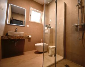 a bathroom with a toilet and a sink and a shower at Dubrovnik Icy Guest House in Dubrovnik