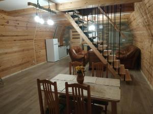 a dining room with a table and a staircase at Szewilla in Szewnia