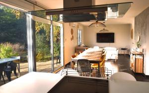 a kitchen and dining room with a table and chairs at Villa Spacieuse au Calme Absolu avec Grande Piscine Jacuzzi Chauffé - Grand Jardin Sans Vis a vis- Salle de Jeux avec Fresque du Nougat - Ideal Familles et Groupes Drome Provencale in Montélimar +95 photos