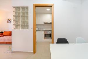 a room with a kitchen and a dining room at 1 Bed Apartment with pool La Red in El Campello +11 photos