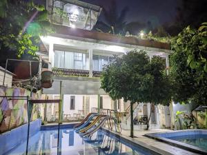a resort with a swimming pool and a slide at Sarasutha hotel and pool in Lembuak