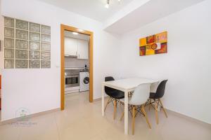 a kitchen and dining room with a table and chairs at 1 Bed Apartment with pool La Red in El Campello