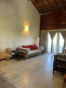 a bedroom with a bed and a table in a room at App Lory KiteVillage in Uruau