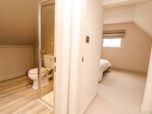a bathroom with a toilet and a window at Egerton Cottage in Crewe +22 photos
