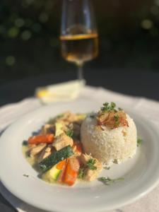 a plate of food with rice and vegetables and a glass of wine at Smart sleep in Watrange +31 photos