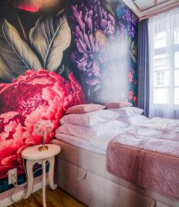 a bedroom with a flower mural on the wall at Das Haus Am Markt in Traben-Trarbach