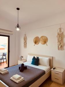 a bedroom with a bed with two towels on it at Villa White in Ksamil
