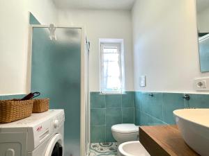 a bathroom with a washer and dryer in it at DOMUS MARI a due passi dal mare Anzio Cincinnato in Anzio