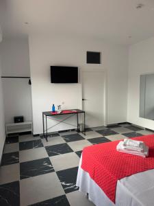 a room with a room with a table and a red bed at B6 Hotel in San Fulgencio