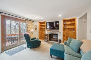 a living room with a couch and chairs and a television at Chatiemac 42F - Quiet & Cozy 3-Bedroom Retreat in North Creek