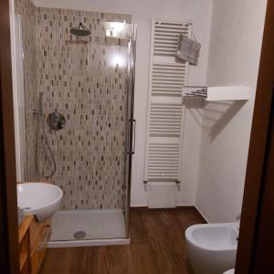 a bathroom with a shower and a toilet and a sink at 1 STEP ON THE LAKE in Clusane sul Lago +24 photos