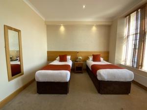 Postel nebo postele na pokoji v ubytování Victoria Hotel