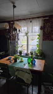 a room with a wooden table with plants on it at Private room in a 250 years old house in Helsinki