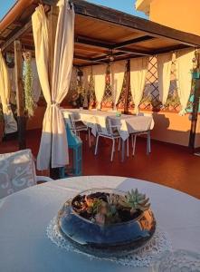 a table with a bowl of food on top of it at Belli come il Sole in Serri