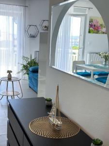 a living room with a table and a mirror at Apartman Stipić 2 in Kaštela +59 photos