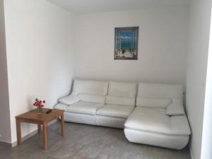 a living room with a white couch and a table at Apartment IB Studio Pag6 in Kustići