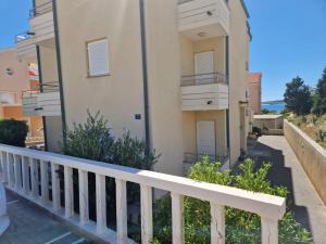 a balcony of a building with a white railing at Apartment IB Studio Pag6 in Kustići