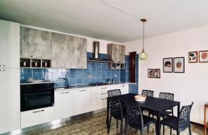 a kitchen with a table and chairs in a room at Casa Costa in Lipari