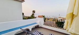 a balcony with chairs and a view of the ocean at Casa Costa in Lipari