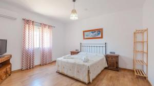 a bedroom with a bed and a tv in it at Villa Ortega Alba Alcalá La Real by Ruralidays in Alcalá la Real +17 photos