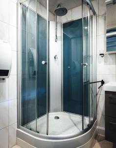 a shower with a glass door in a bathroom at Natur tanken im Schwarzwald in Sasbachwalden