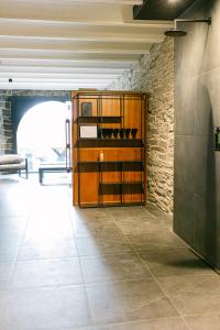 a room with a wooden cabinet and a stone wall at Châteaux de Méliris in Tenneville