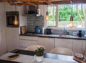 a kitchen with a table and chairs and a sink at Chalet Klein Geluk in Lanaken