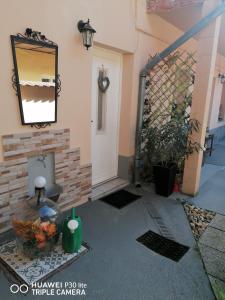a garage with a white door and a mirror at Nonna Vendégház in Esztergom