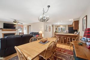 a living room with a table and a couch at Sagamore 46G - Adirondack Retreat for All Seasons in North Creek +22 photos