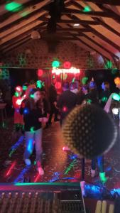 a group of people dancing in a room with lights at VVF Haute Loire Saint-Julien-Chapteuil in Saint-Julien-Chapteuil