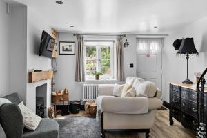 a living room with a couch and a chair at Apothecary Cottage - Pet Friendly Wedmore Couples Cottage - Free WiFi - Free Parking in Wedmore