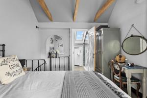 a bedroom with a bed and a table and a mirror at Apothecary Cottage - Pet Friendly Wedmore Couples Cottage - Free WiFi - Free Parking in Wedmore