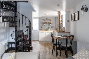 a living room and kitchen with a table and chairs at Apothecary Cottage - Pet Friendly Wedmore Couples Cottage - Free WiFi - Free Parking in Wedmore