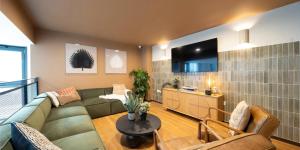 a living room with a couch and a table at Canvas Glasgow - in City Centre in Glasgow +36 photos