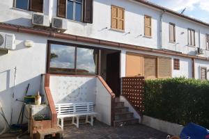 a white house with a staircase and a bench at Villino Le Palme, Laghi Di Sibari, Cosenza in I Casoni